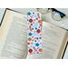 floral bookmark has a white background with different colors of flowers and leaves: orange (light and dark), blue (light and dark), and red