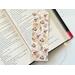 this rustic floral bookmark has a rustic brown background with rustic flowers and leaves with brown blocks