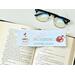 this coffee bookmark has a light blue background with the word in 'Good...' in pink and the words 'Morning Coffee Lover' in green in the middle. there are coffee cup on either side
