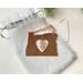 Photo of Copper I Love Oregon Ornament with Heart shape cutout in the middle and an Oregon Sunstone gemstone, shown with muslin gift bag