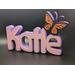 Base Lavender.  Top Letter Color Pink.  Emoji Butterfly.  Black outline with Silk Orange wing markings.