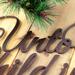 Close up of copper vein powder coat on our Unto Us A Child Is Born metal sign.