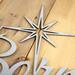 Close up of raw steel on our Unto Us A Child Is Born metal sign.