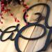 Close up of matte black powder coat on our Unto Us A Child Is Born metal sign.