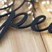 Close up of matte black powder coat on our peace doves metal wall decor.