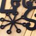 Close up of matte black powder coat on our Let it Snow metal sign.