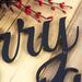 Close up of matte black powder coat on our Merry Christmas metal sign.