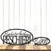 Oval sign with first names and family last name, along with an established year metal sign, in matte black powder coat.