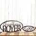 Oval sign with first names and family last name, along with an established year metal sign, in copper vein powder coat. 