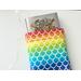 a medium size book is peeking out of the rainbow book sleeve