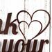 Close up of hearts on our Think with your Heart metal sign, in copper vein powder coat.