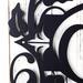 Close up of vines and fleur de lis on our metal monogram sign, in matte black powder coat.