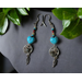 These dangle earrings are made of blue turquoise blue stones with other beads and tiny metal dream catchers