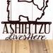Close up of wording on our A Shih Tzu Lives Here metal wall art, in copper vein powder coat.