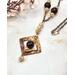 square washer style flame colored copper pendant with purple quartz and cream colored crystal beads on copper chain with hook clasp