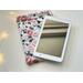 the ebook is on top of kindle pouch on a white table with fairy lights on the left side
