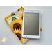 the ereader is on top of the kindle sleeve on a white table with fairy lights on the left side