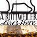 Close up of A Rottweiler Lives Here wording on our Rottweiler metal wall art, in matte black powder coat.