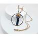 necklace features blue quartz pendant stone inside gold stainless steel circle with blue crystals wire wrapped on top hung on gold chain
