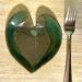 6x6" heart shaped plate with Hosta plant texture. Glazed with a dark green rim and a mixture of blue and grey throughout the middle. 