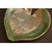 6x6" heart shaped plate with Hosta plant texture. Glazed with a dark green rim and a mixture of blue and grey throughout the middle. 