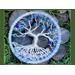 3 inch tree of life sits in bed of moss atop river rock 