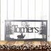 Rectangular metal family name plaque with buck and doe deer, in silver vein powder coat.