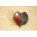 Ceramic heart shaped spoon rest. Glazed in red and blue. Approximately 3"x3.5"