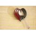 Ceramic heart shaped spoon rest. Glazed in red and blue. Approximately 3"x3.5"
