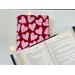 an open book on top of the book jacket on a white table