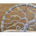 close-up view left side twisted aluminum branches wrapped perfectly around metal hoop