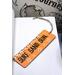 Front of bookmark with orange background, black handwritten lettering, black and white dot art, turtles and starfish.  Jute rope tassel.