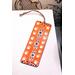 Front of bookmark  - orange background, hand painted paw print along sides, various dot art designs top, middle & bottom.  Jute rope tassel