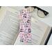 this cute cats bookmark has a pink background with cute kitties pink hearts and flower along with paw prints and 'I love you' all over the laminated bookmark.