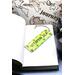 Front of bookmark, lime green background, black handwritten lettering, turtles, starfish and jute rope tassel.