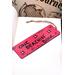 Front of bookmark hot pink background, black handwritten lettering, turtles, starfish, various dot art.  Jute rope tassel.
