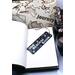 Front of bookmark, black background, handwritten lettering in white, starfish, turtles, jute rope tassel.