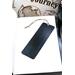 Back of bookmark in solid black, jute rope tassel.
