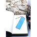 Back of bookmark, solid light blue.  Jute rope tassel.