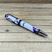 large purple desk pen