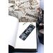 Front of bookmark, black background with handwritten white lettering and various white/hot pink dot art around the edges.  Jute rope tassel.