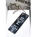 Front of bookmark, black background with handwritten white lettering and various white/hot pink dot art around the edges.  Jute rope tassel.