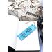 Front of bookmark, light blue background, handwritten lettering in black, white and black dot art designs and jute rope tassel.
