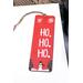 Front of bookmark, red background, snowflakes, Christmas Trees, snowman, handwritten white lettering and jute rope for tassel.