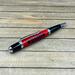 red and black jeep pen