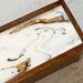 Tea box with white, gold and black top.