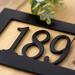 Close up of matte black powder coat for rectangular metal address sign.