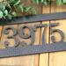 Close up of silver vein powder coat on our hanging metal address sign.