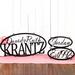 Hanging oval family name, child name, and established metal signs, in matte black powder coat.