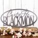 Oval family name metal sign with first names and last name, in silver vein powder coat.